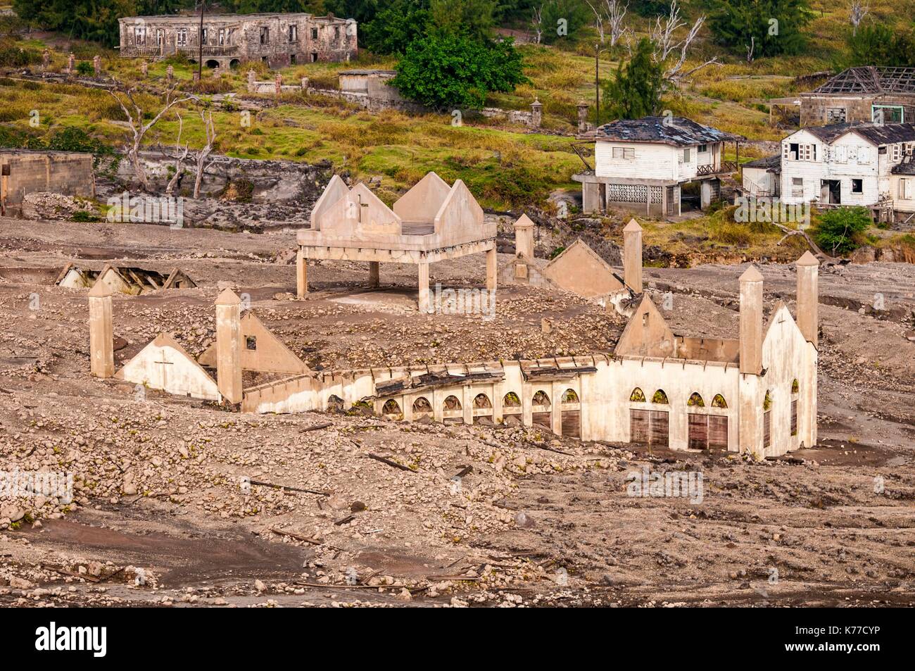 United Kingdom, Montserrat, English-speaking Caribbean, Plymouth, aerial view from the helicopter to the Montserrat Volcano Observatory of the ancient capital, destroyed by pyroclastic flows from the eruption of the stratovolcano of Soufriere Hills in 1997, today prohibited area because of the daily activity of the volcano and its toxic emanations, here the Pentecostal church (aerial view) Stock Photo