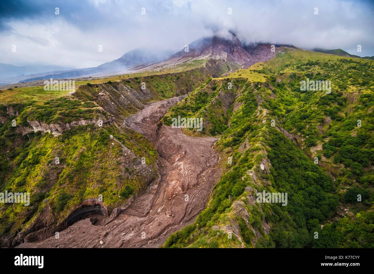 United Kingdom, Montserrat, English-speaking Caribbean, the flanks of the volcano bearing the stigmata of pyroclastic flows, the Soufriere Hills volcano (915 m) in the background (aerial view) Stock Photo