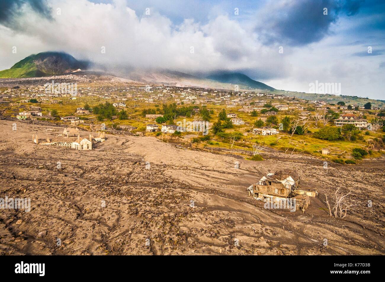 United Kingdom, Montserrat, English-speaking Caribbean, Plymouth, aerial view from the helicopter to the Montserrat Volcano Observatory of the ancient capital, destroyed by pyroclastic flows from the eruption of the stratovolcano of Soufriere Hills (in the background) in 1997, today prohibited area because of the daily activity of the volcano and its toxic emanations (aerial view) Stock Photo