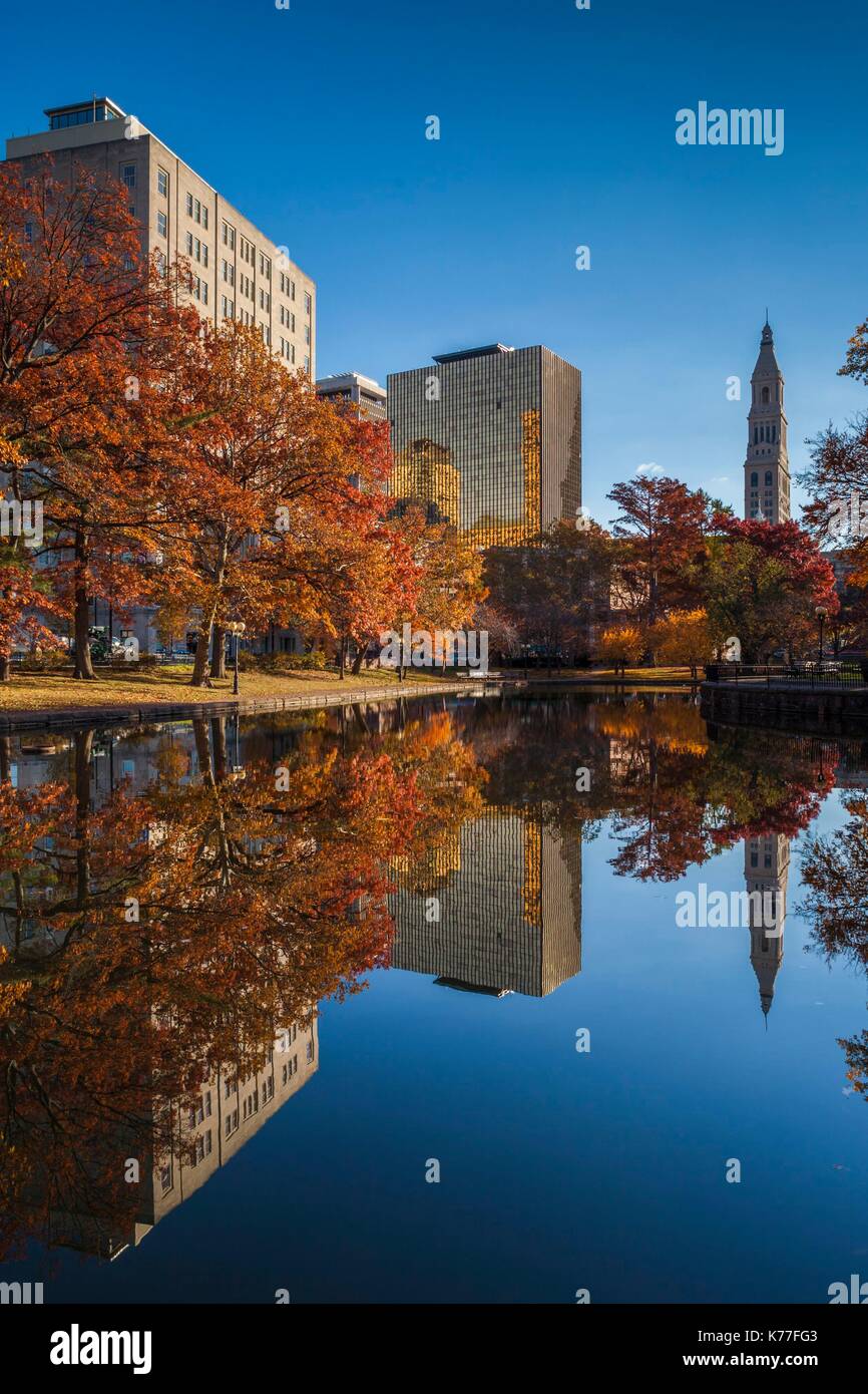 United States, Connecticut, Hartford, Bushnell Park, reflection of office buildings and Travelers Tower, Haeadquarters of the Travelers Insurance Company, autumn Stock Photo