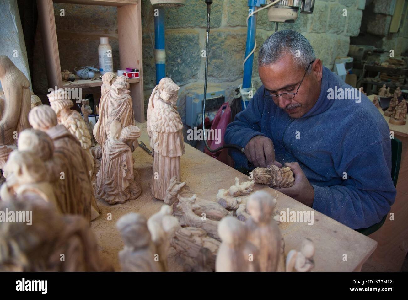 Israel, West Bank, Bethlehem, Arab Christian artisan making wooden religious figures, R, MR ISL