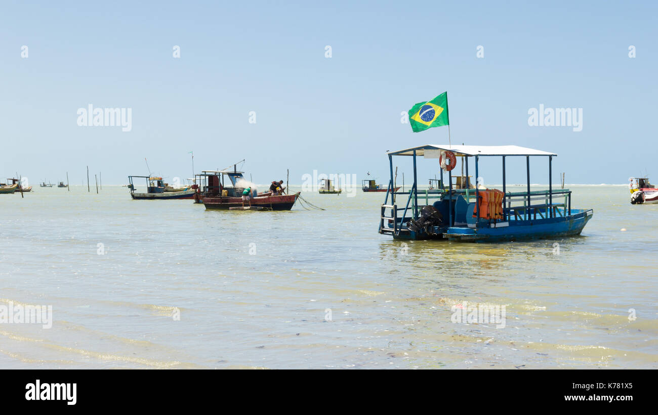 Maceio, Brazil - September, 05 2017. Brazilian coast with several boats moored on the coast. The flag of Brazil is in one of them. Stock Photo