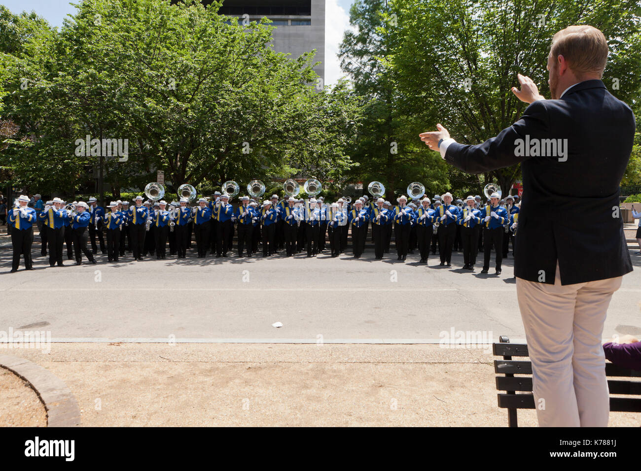 High school marching band teacher and students practicing for a parade - USA Stock Photo