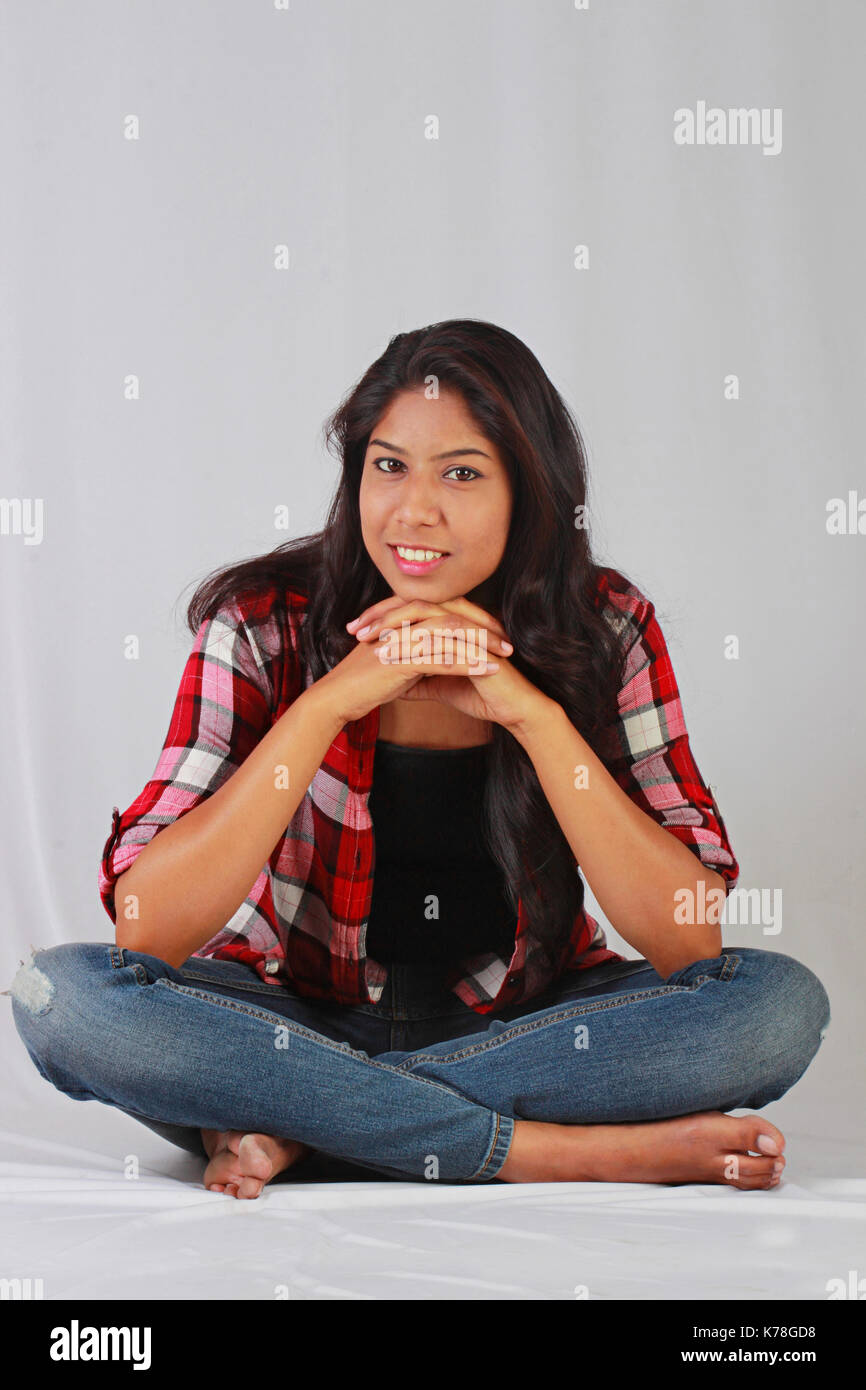 Young Indian girl in casual attire sitting cross legged Stock Photo Alamy