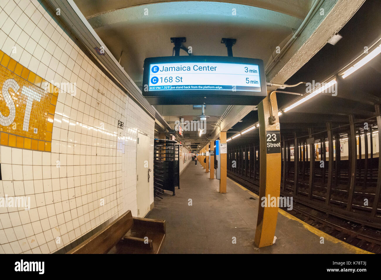 A new digital countdown clock installed in the New York subway is seen at the 23rd Street station serving the C and E lines on Monday, September 11, 2017. The new technology uses Bluetooth receivers in the stations connected via the existing wireless network. The first and last cars of the trains have Bluetooth transmitters. The new clocks have faced criticism because of their placement, in the center of every platform and not at the entrances and some have been obscured by other infrastructure. (© Richard B. Levine) Stock Photo