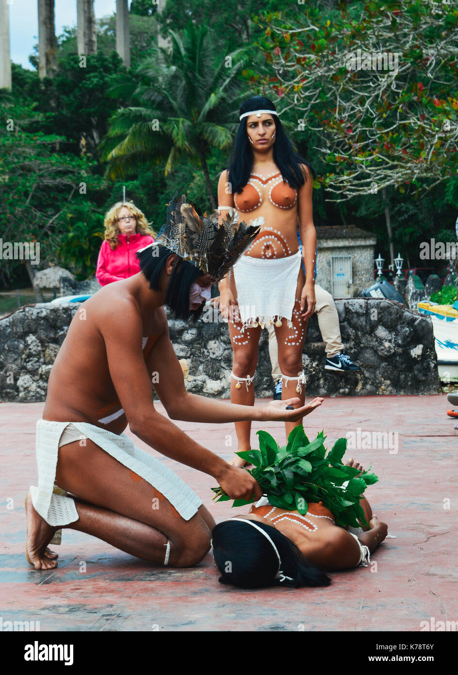 A Taino man and woman natives of Cuba perform a traditional healing ritual for tourists Stock Photo