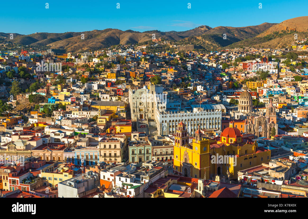 The colorful cityscape of Guanajuato city at sunset with its colorful housing and Our Lady of Guanajuato cathedral in central Mexico. Stock Photo