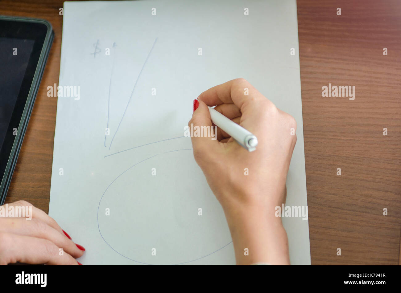 girl with a pen in her hand and a piece of paper Stock Photo - Alamy