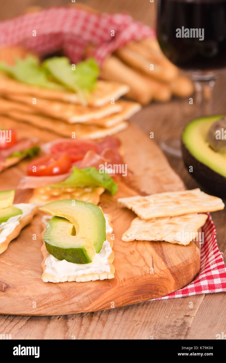Crackers with ham and avocado. Stock Photo