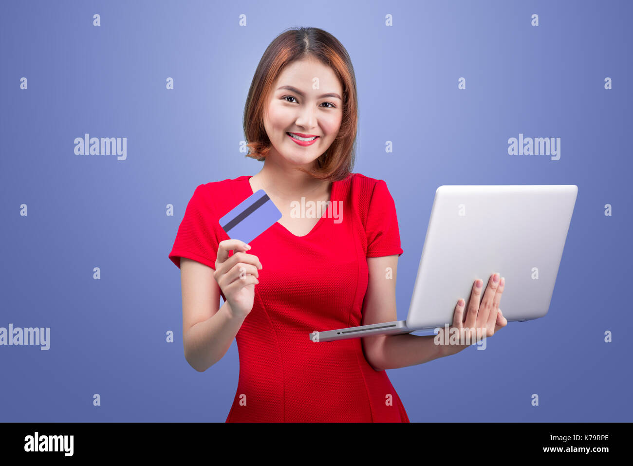 Online shopping. Asian woman holding laptop and credit card ready to pay Stock Photo Alamy
