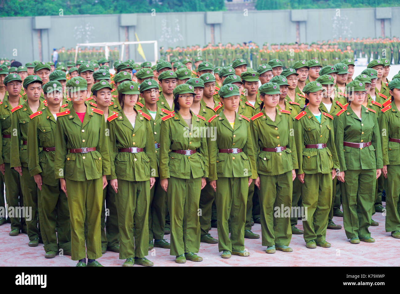Changsha, China - September 5, 2007: Male and female Chinese university students in green uniforms line up in formation for compulsory military traini Stock Photo