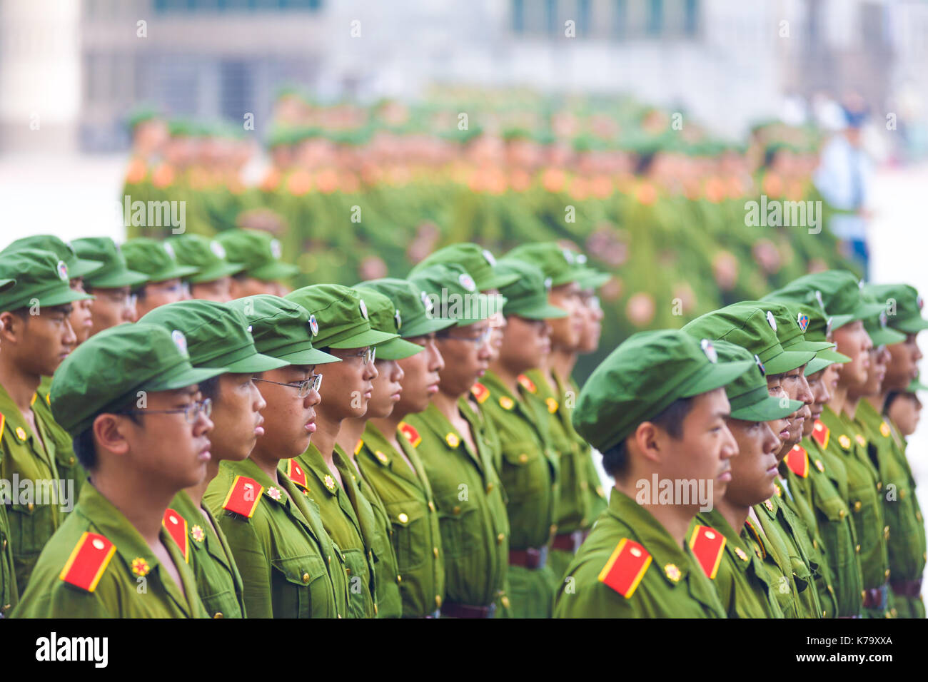 Changsha, China - September 5, 2007: Rows of male Chinese university students in communist green uniforms line up in formation for compulsory military Stock Photo