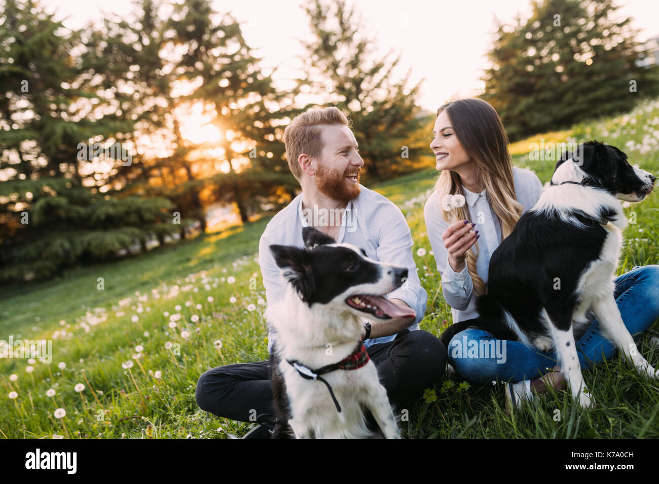 Romantic couple in love walking dogs and bonding Stock Photo - Alamy