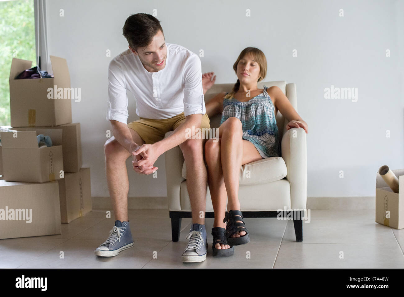 Couple taking break from unpacking in new house Stock Photo