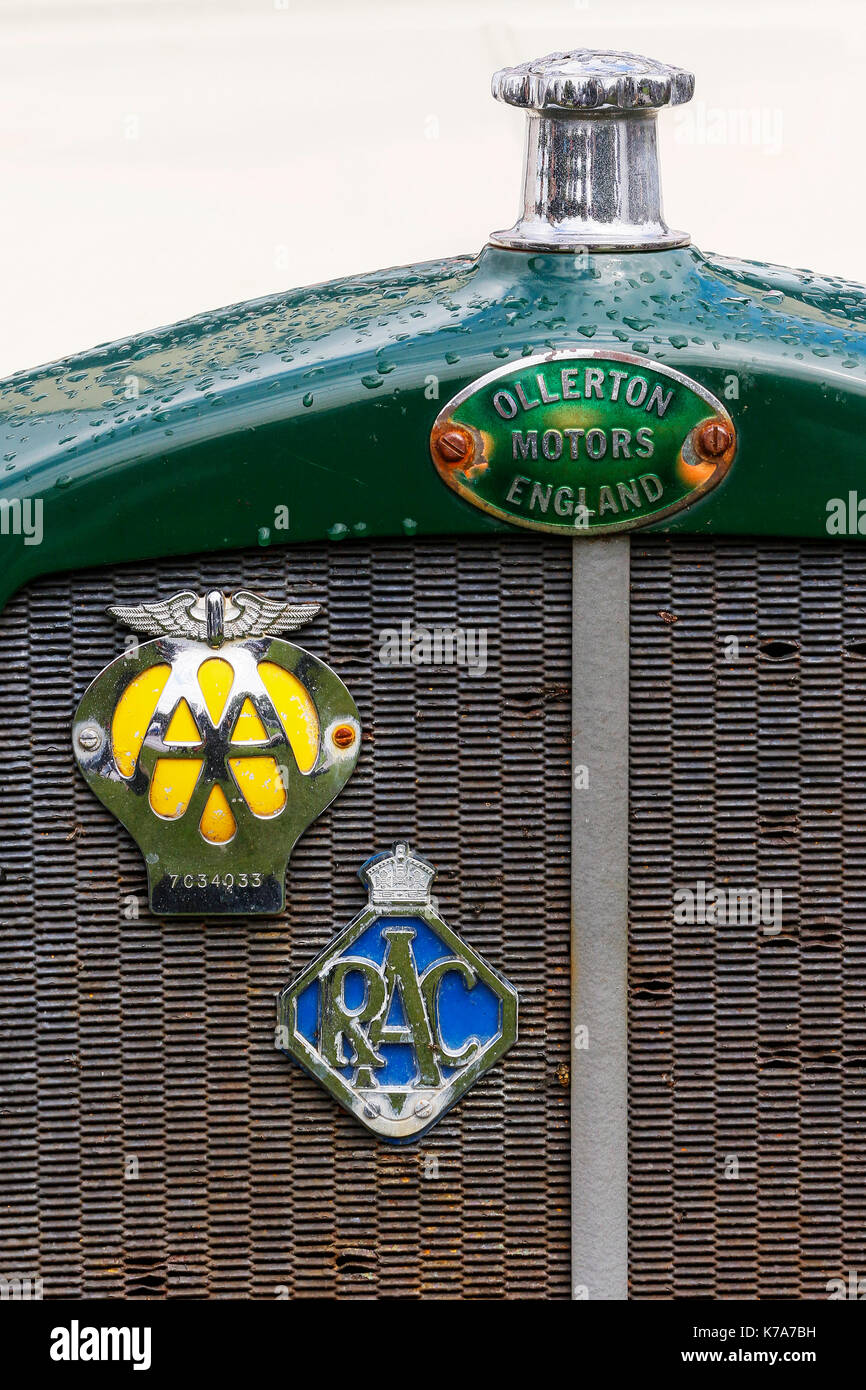Front grill of an Ollerton van with an RAC badge and an AA badge screwed onto the rusty front grill. Stock Photo