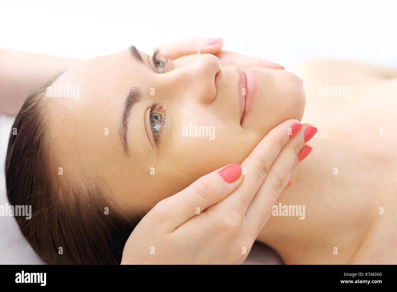 Face massage. Woman in beauty parlor during facial massage.  Face massage. Woman in beauty parlor during facial massage. Stock Photo