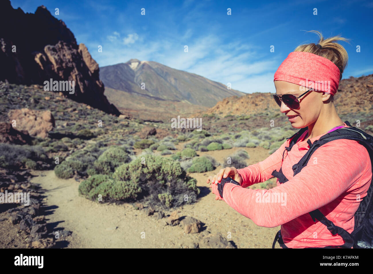 Trail running woman on mountain trail looking at sportwatch checking performance heart pulse or GPS position nd track. Cross country running in beau Stock Photo Alamy