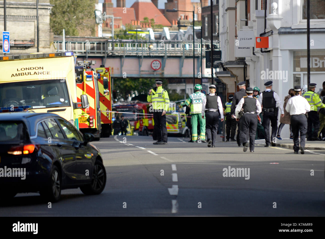 A terrorist bomb explosion has occurred at Parsons Green Underground Station London. Emergency services pictured clearing the scene and assisting injured Stock Photo