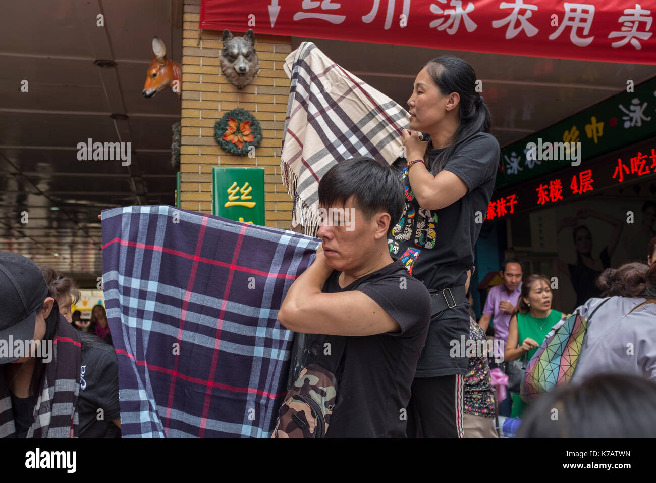 Beijing, China. 15th Sep, 2017. Shopkeepers sell each scarf for 30RMB ( $4.5 ) as a closing down sale on the last day before the closure of a wholesale market in central Beijing, China. Tianyi Market is the latest wholesale market closes its doors after 25 years of operating and some 1,500 shops are forced out in Beijing. Beijing is hoping to get rid of all wholesale markets within its Fourth Ring Road by 2020 in order to reduce its population by 15 percent, a total of some two million people, by 2020. Credit: Lou Linwei/Alamy Live News Stock Photo