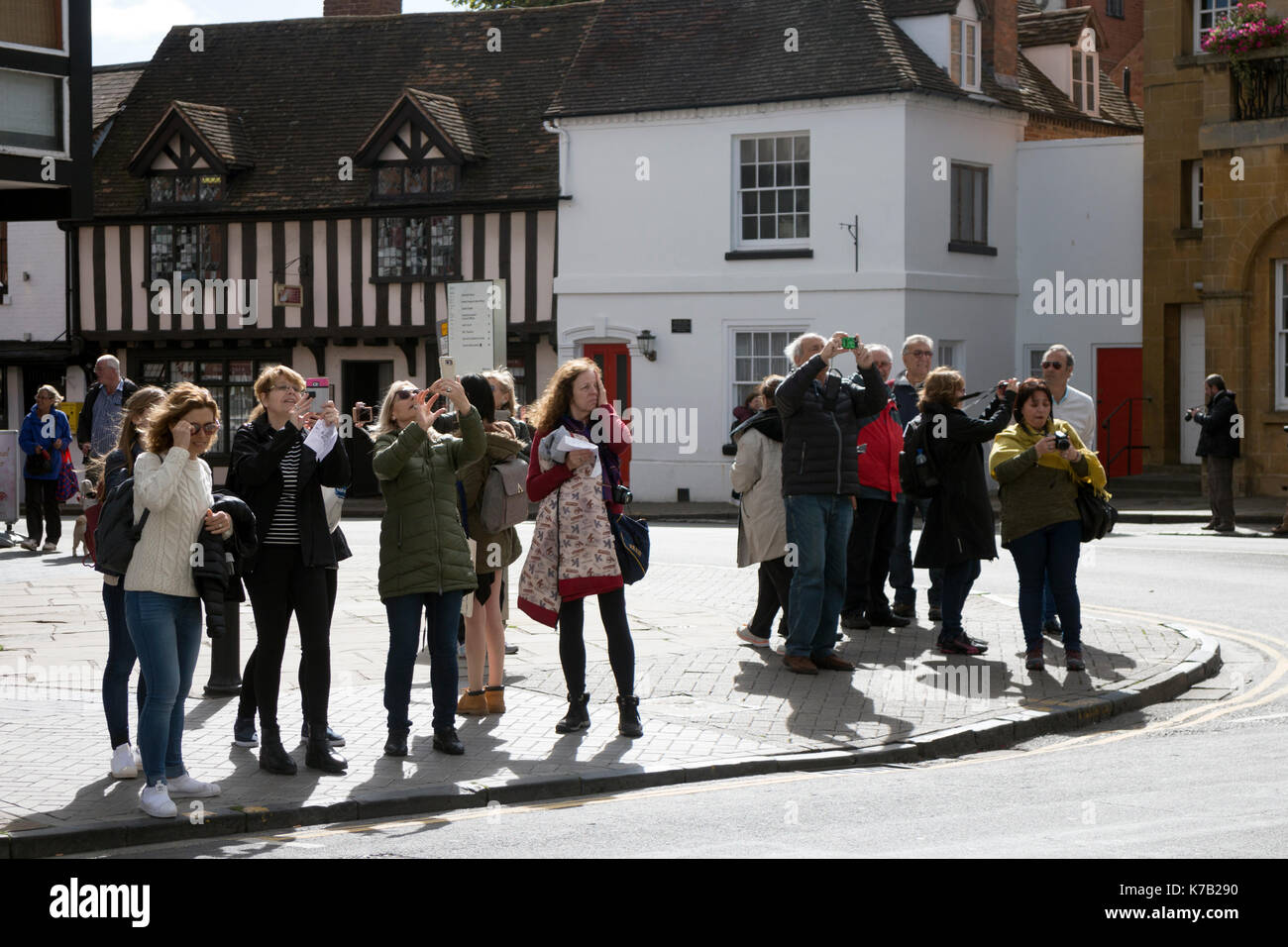 Tourists taking photographs in Stratford-upon-Avon town centre, Warwickshire, England, UK Stock Photo
