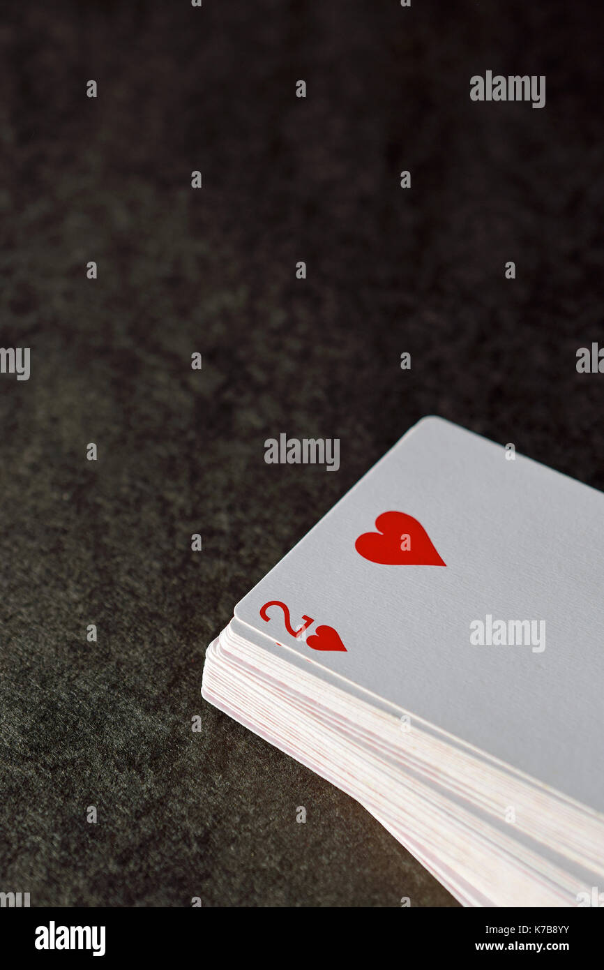 Stack of playing cards, two of hearts on top Stock Photo