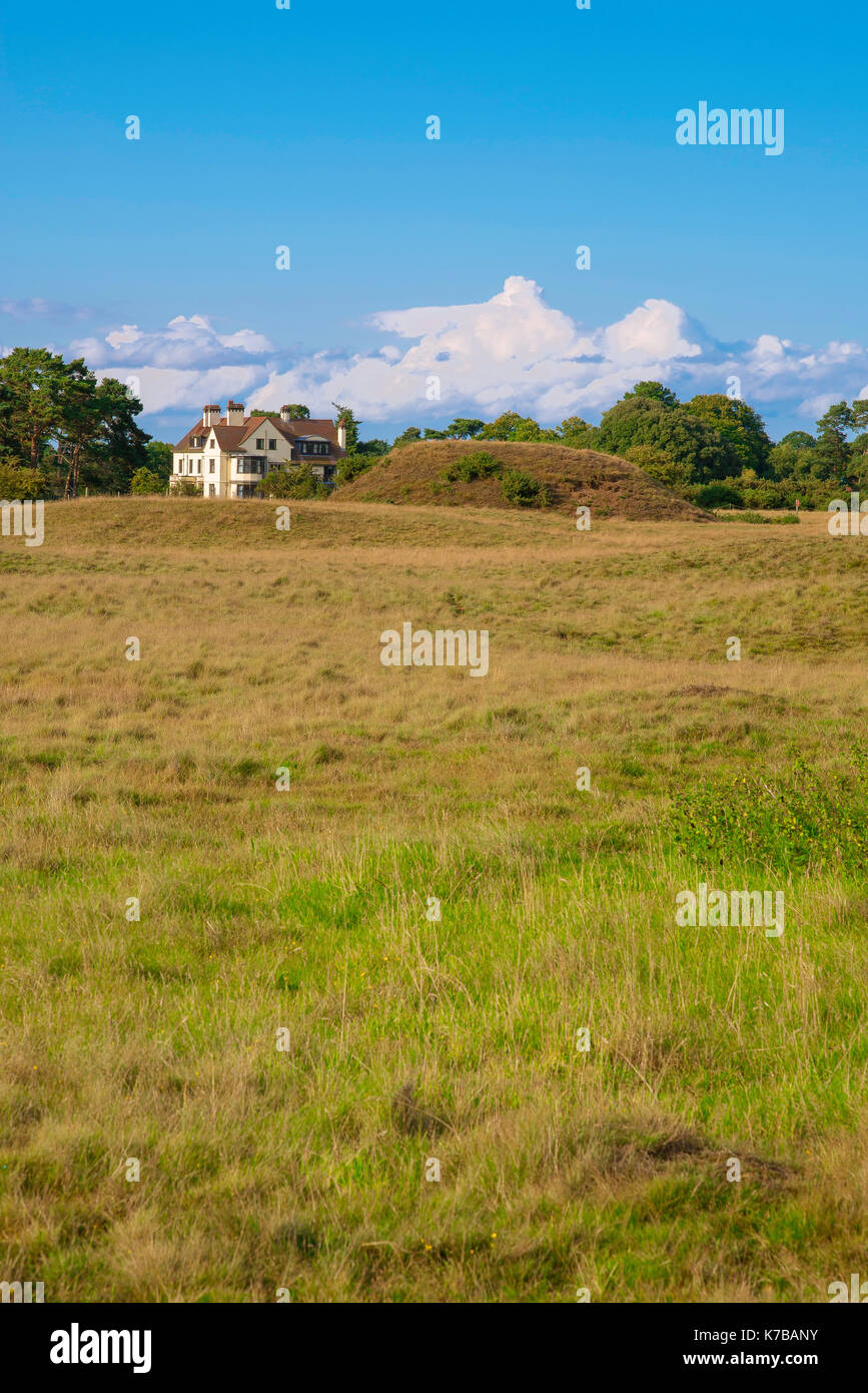 Sutton Hoo UK, view of large Anglo Saxon burial mound with Tranmer House in the background, Sutton Hoo, England, UK. Stock Photo