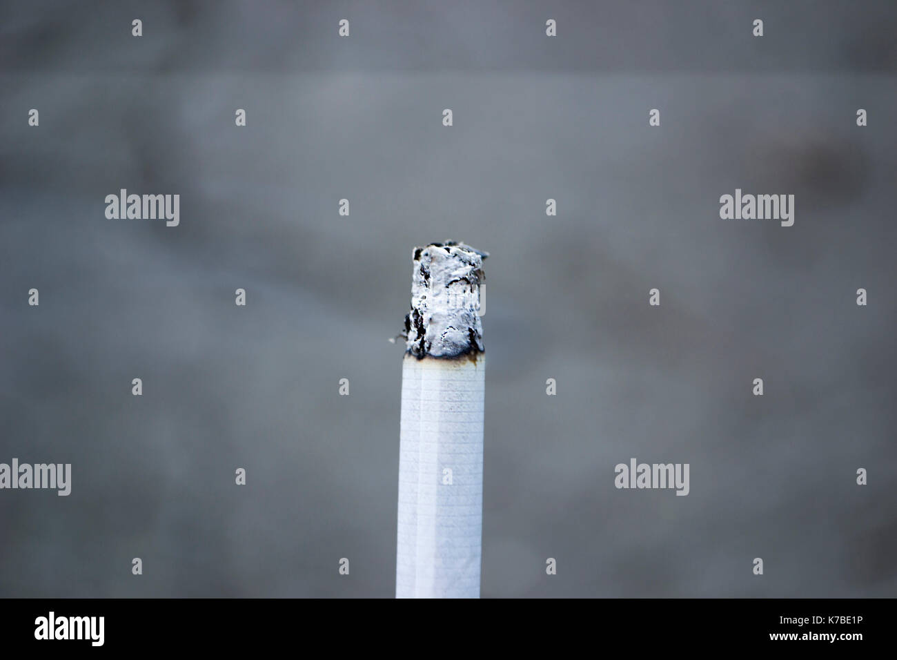 Ashes and smoke from a cigarette. Close-up. Stock Photo