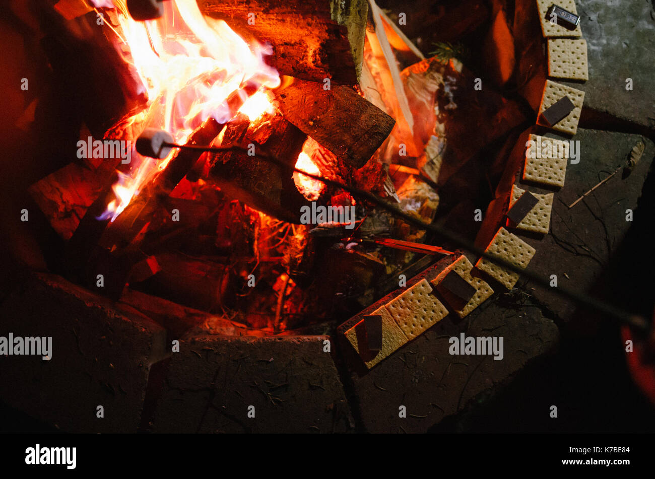 Marshmallow been roasted on fire pit by chocolates and crackers Stock