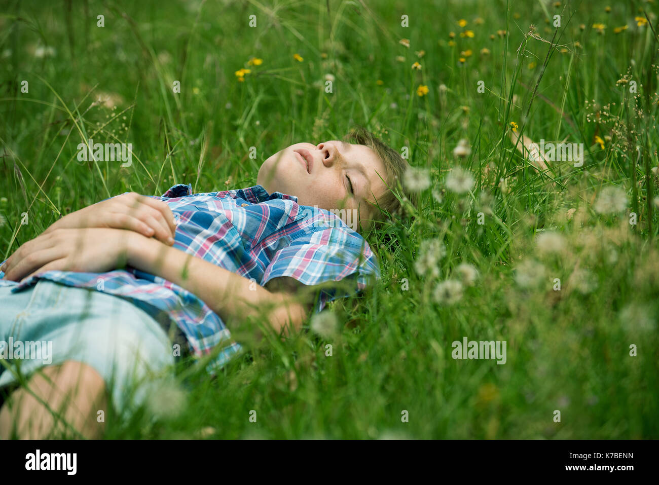 Boy napping on grass Stock Photo