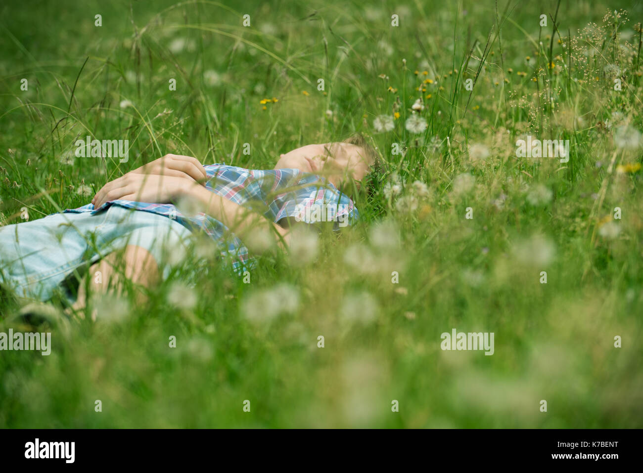 Boy napping on grass Stock Photo