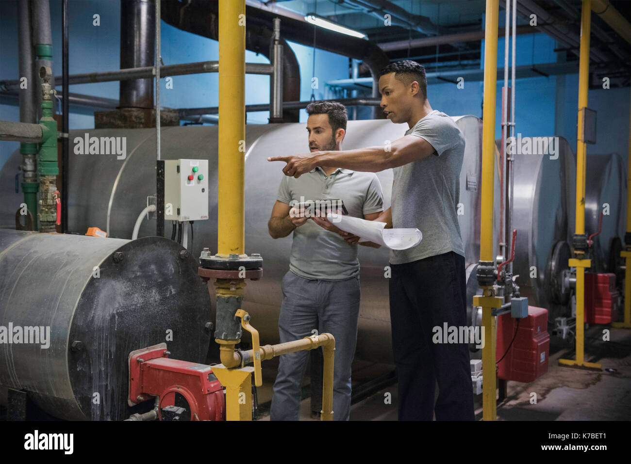 Men working in industrial setting Stock Photo