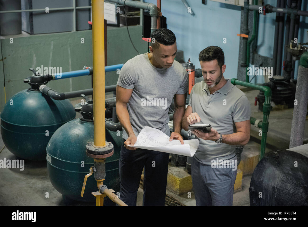 Men working in industrial setting Stock Photo Alamy