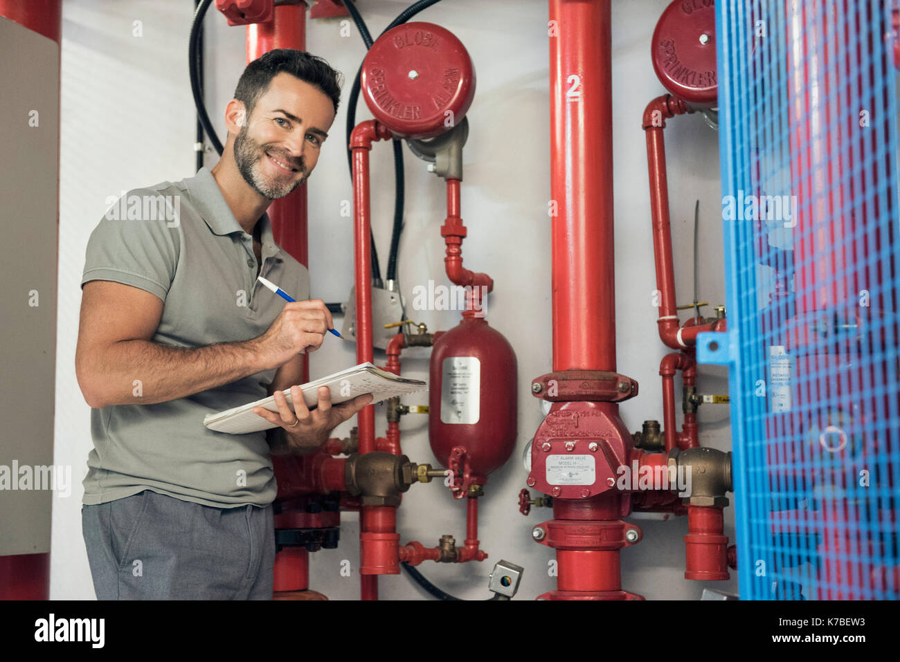 Man inspecting fire protection sprinkler system Stock Photo
