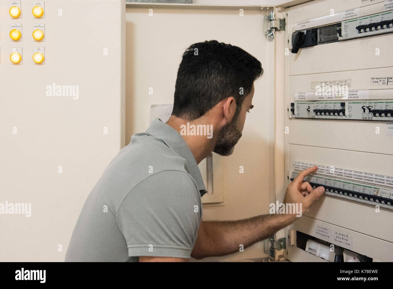 Electrician checking electric control cabinet Stock Photo