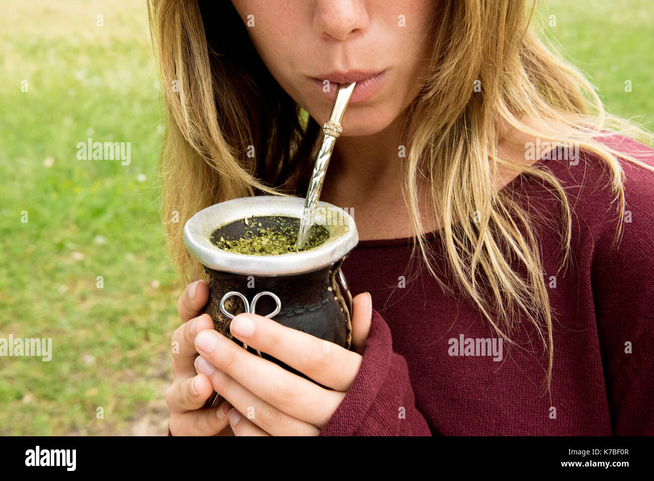 Woman drinking mate from gourd Stock Photo
