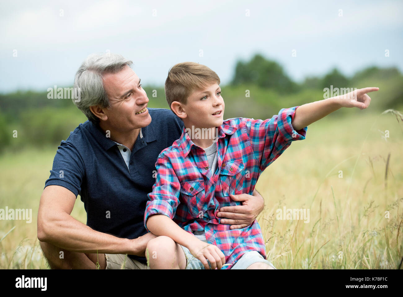 Grandfather and grandson spending time together outdoors Stock Photo
