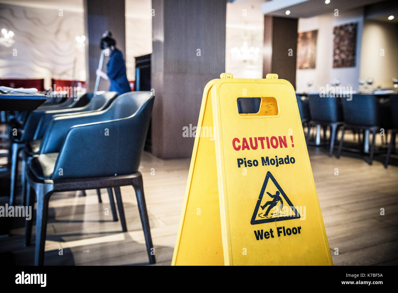 Woman mopping restaurant floor Stock Photo