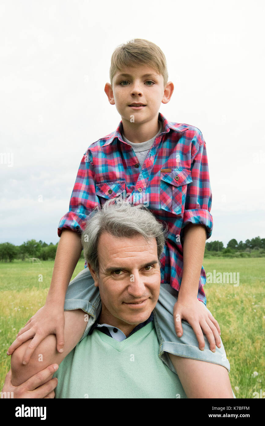 Grandfather carrying grandson on shoulders, portrait Stock Photo