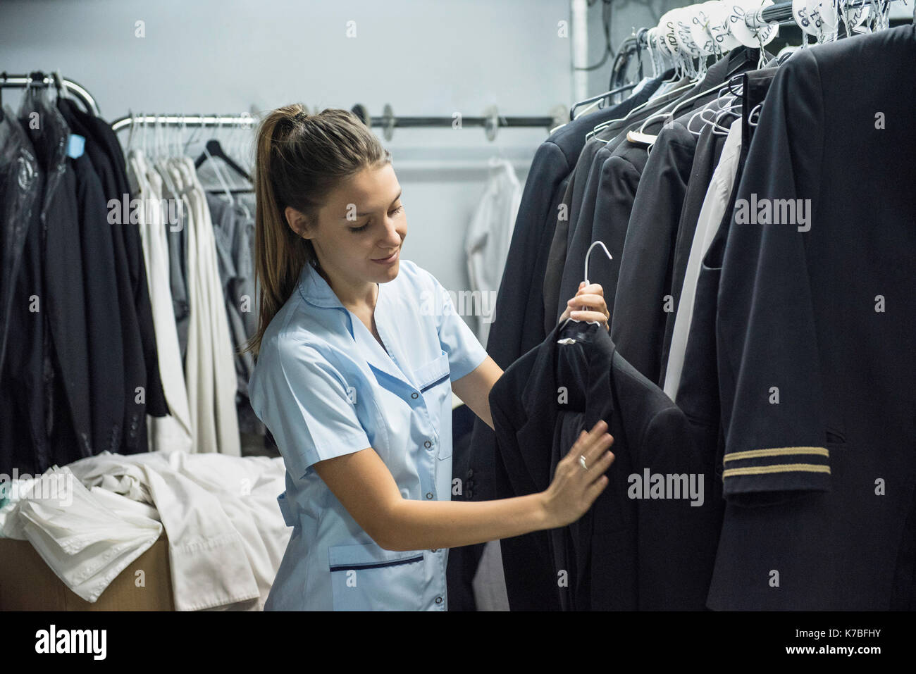 Woman examining blazer Stock Photo