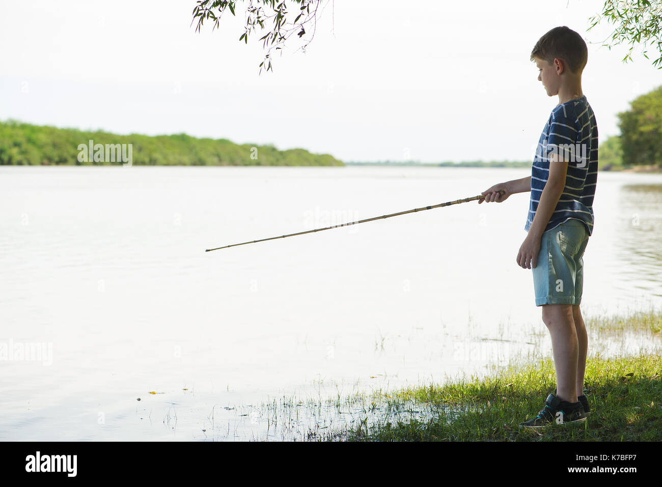 Boy fishing at lake Stock Photo