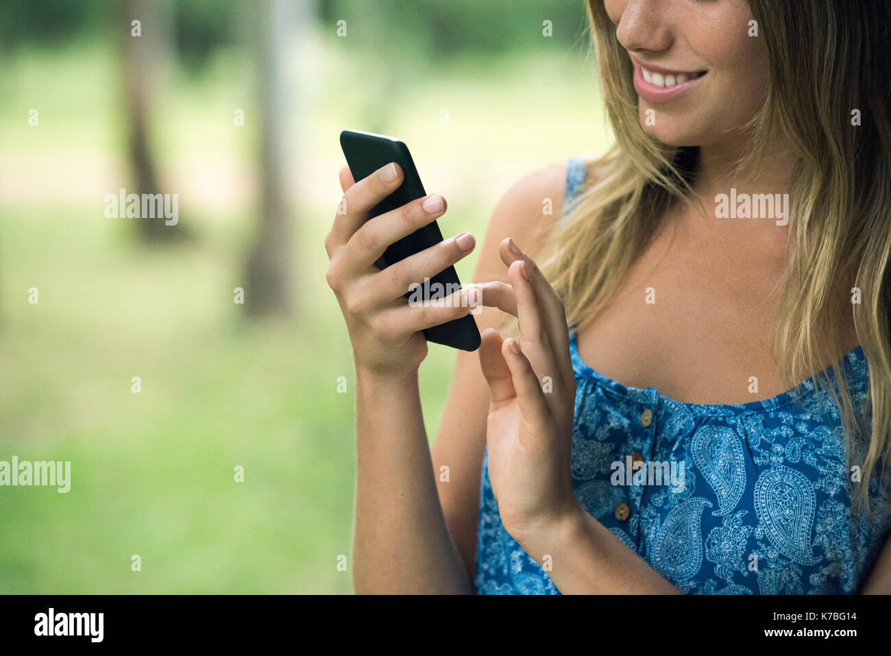 Young woman using smartphone, cropped Stock Photo