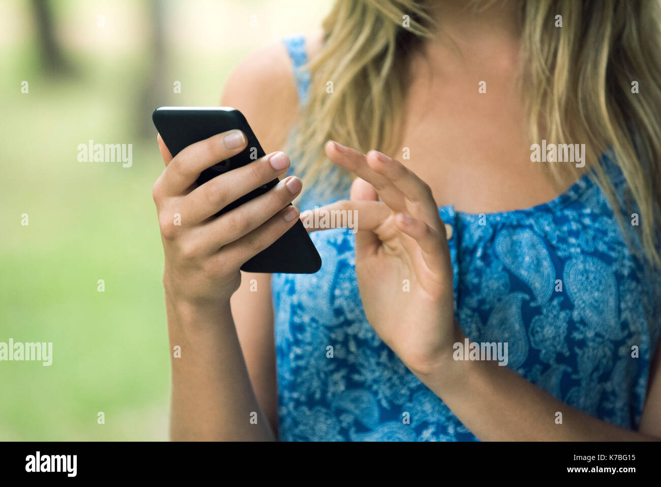 Woman using smartphone, cropped Stock Photo