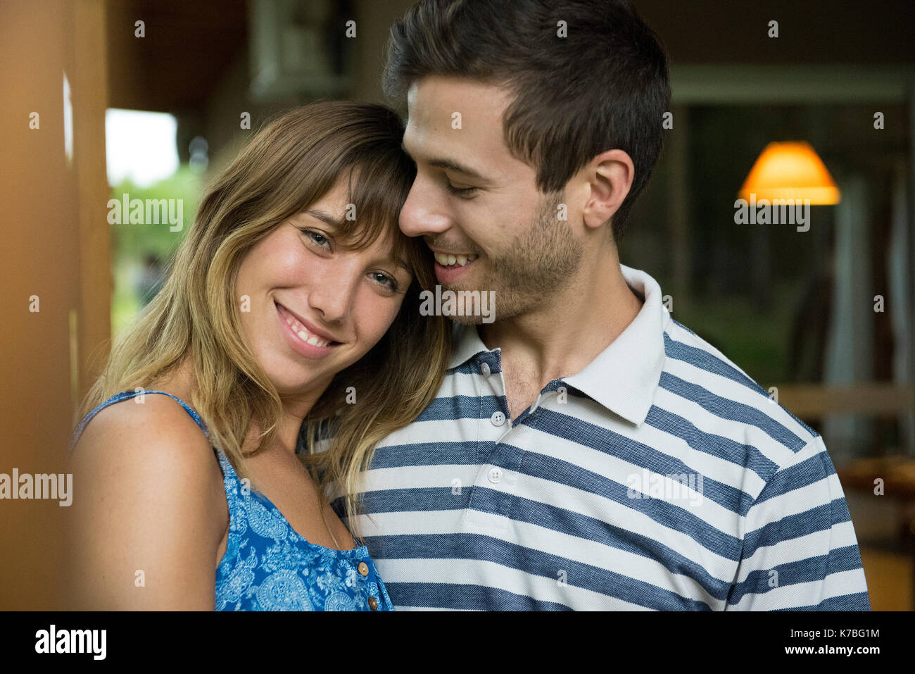 Young woman leaning head on boyfriend's shoulder, portrait Stock Photo