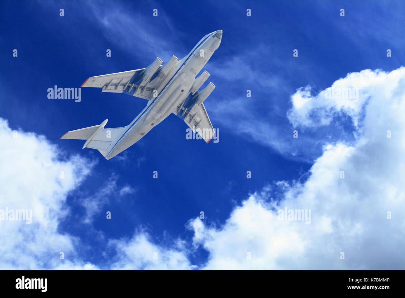 Passenger airplane flying in blue sky with clouds Stock Photo - Alamy