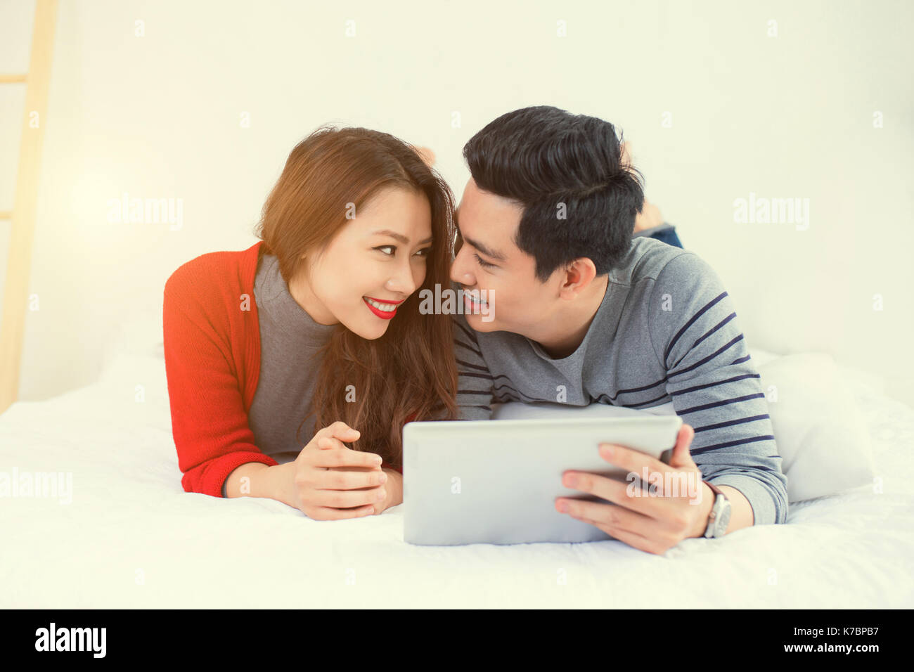 Young asian couple using tablet hi-res stock photography and images - Alamy