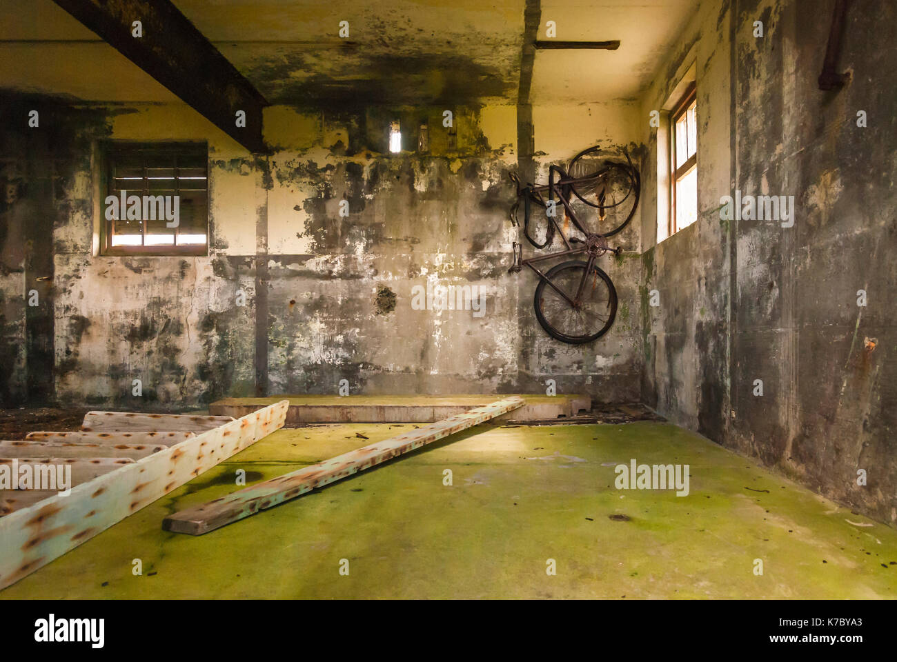 Bicycle hanging on the wall of a WW2 building in Tankerness, Orkney,Scotland. Stock Photo