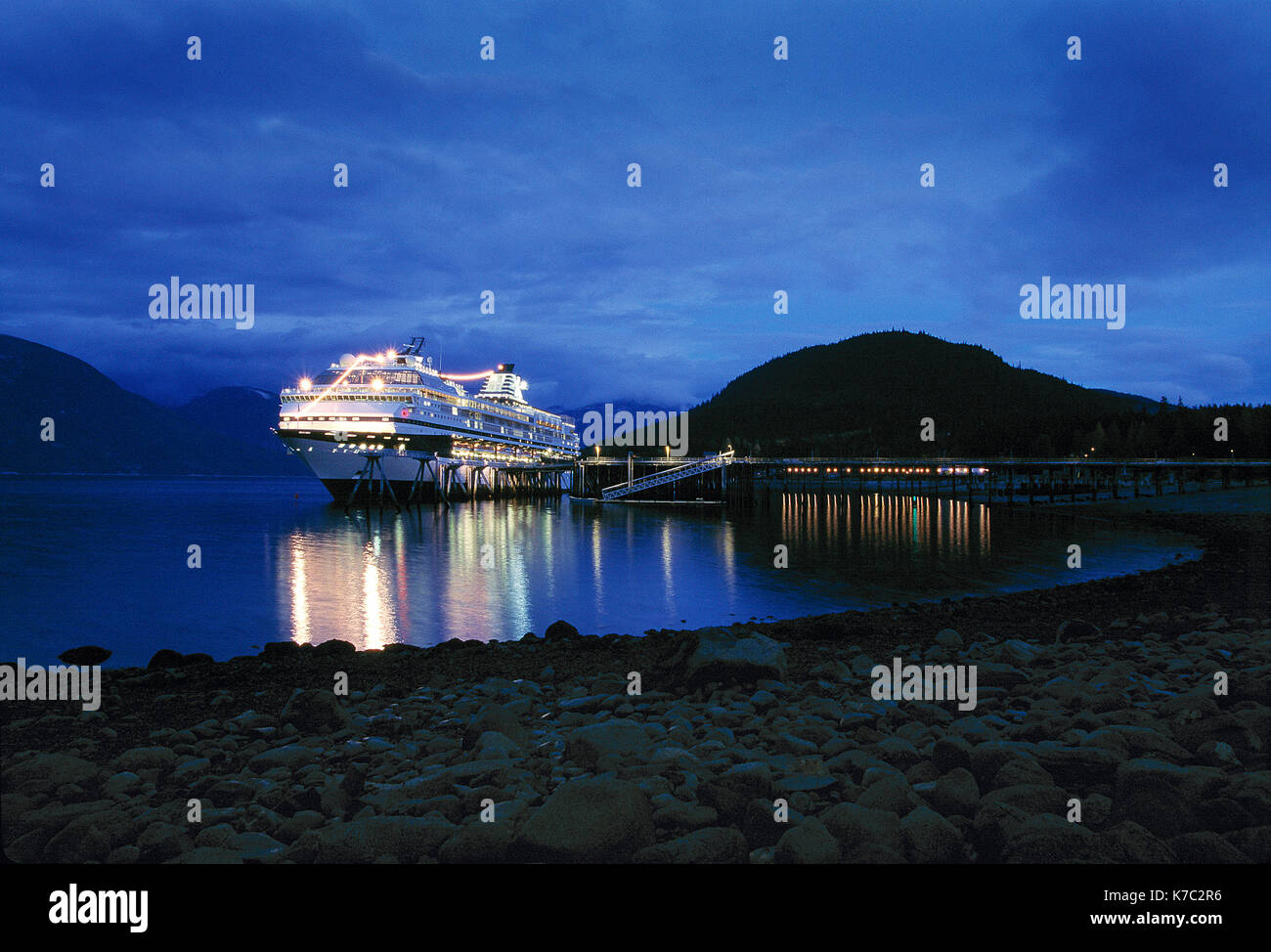 United States of America. Alaska. Haines. Floodlit cruise ship at quayside at night. Stock Photo