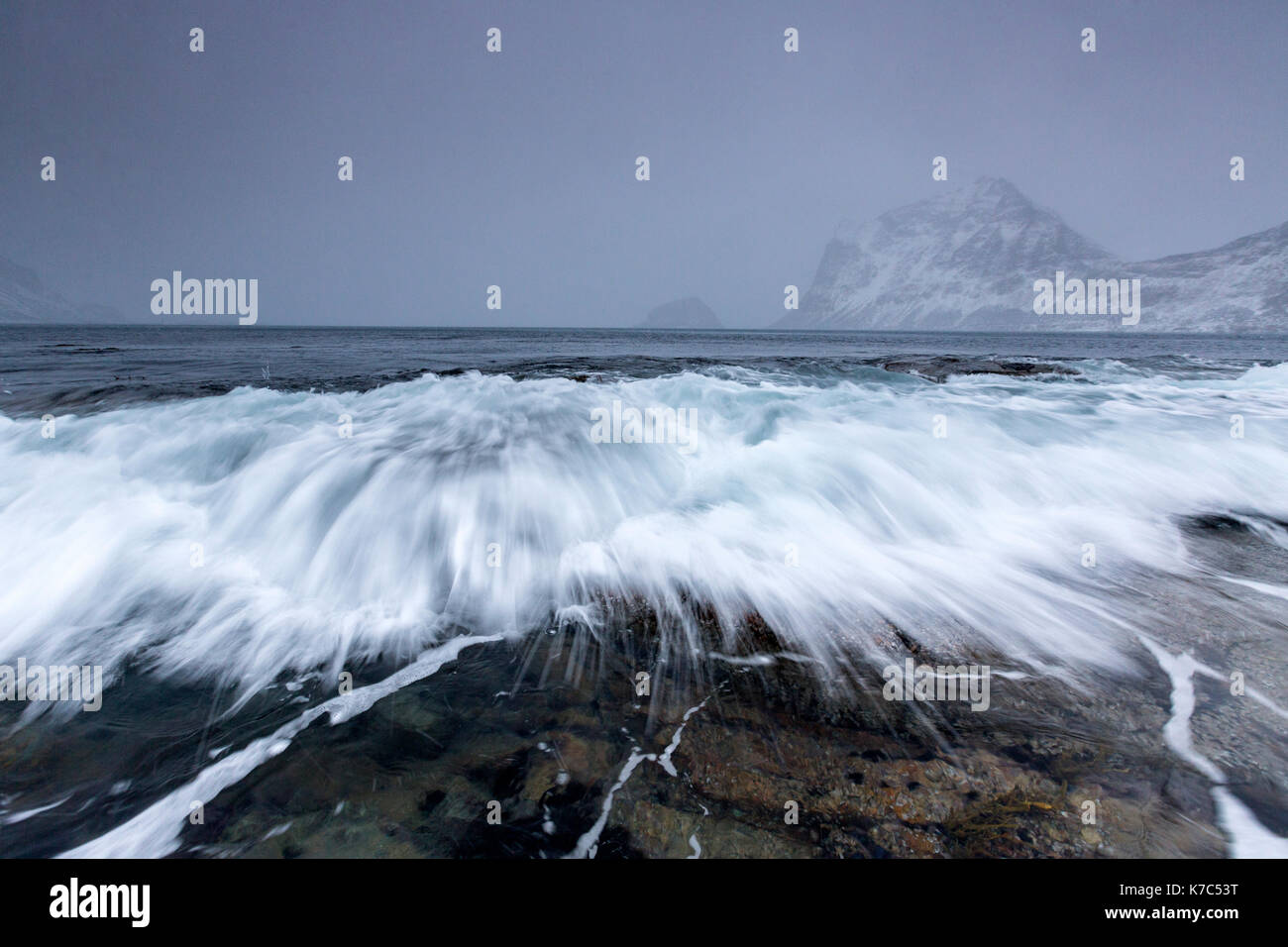Waves crashing on the rocks of the cold sea. Haukland. Lofoten Islands Northern Norway Europe Stock Photo