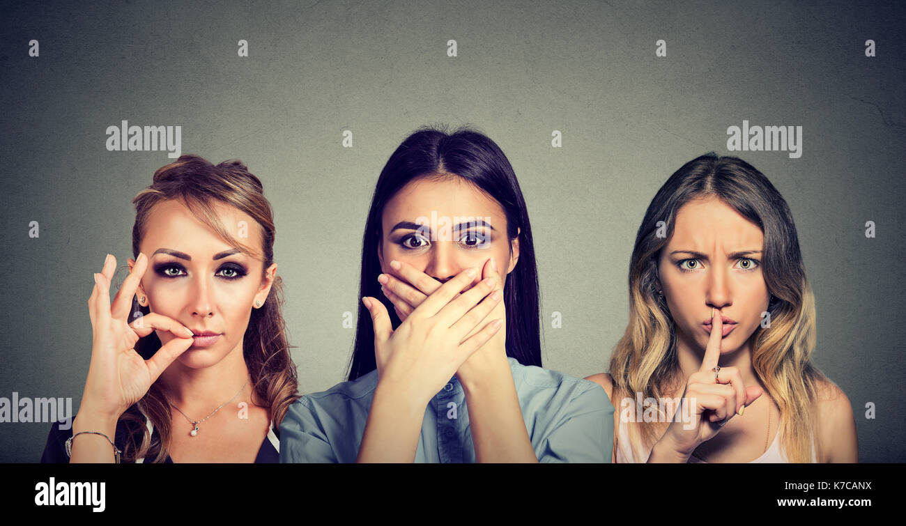 Keep a secret be quiet concept. Three secretive women keeping mouth shut. Stock Photo
