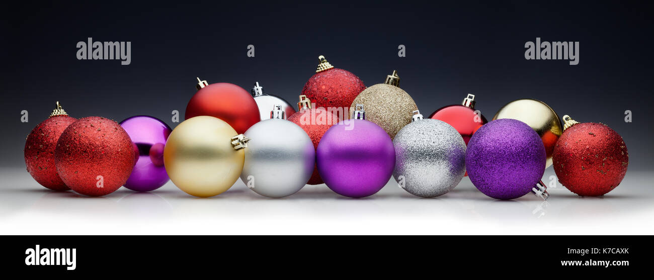 Christmas balls set against black background. Large horizontal layout for banners Stock Photo